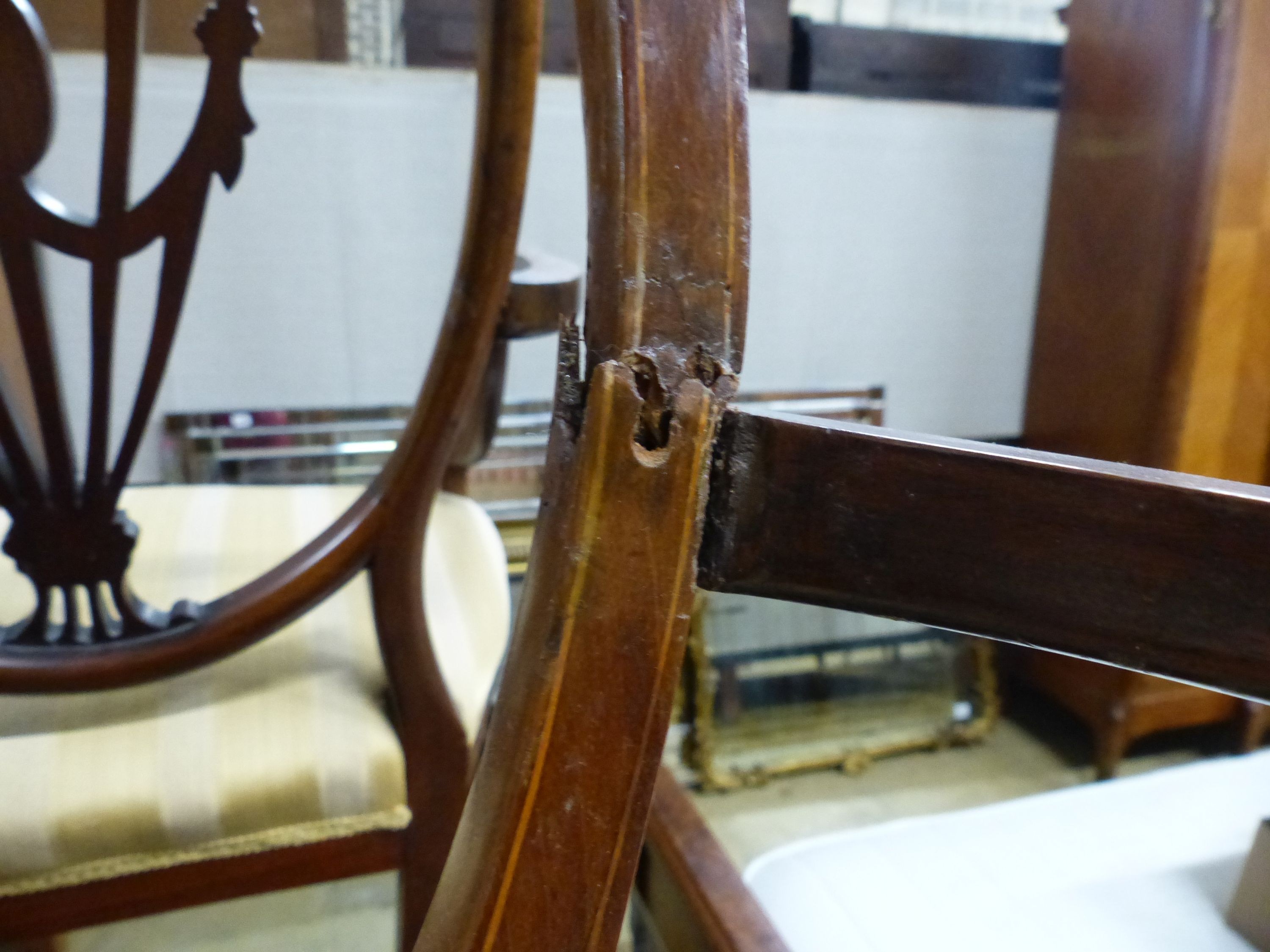 A pair of Edwardian Sheraton revival inlaid mahogany shield back elbow chairs (one a.f.)